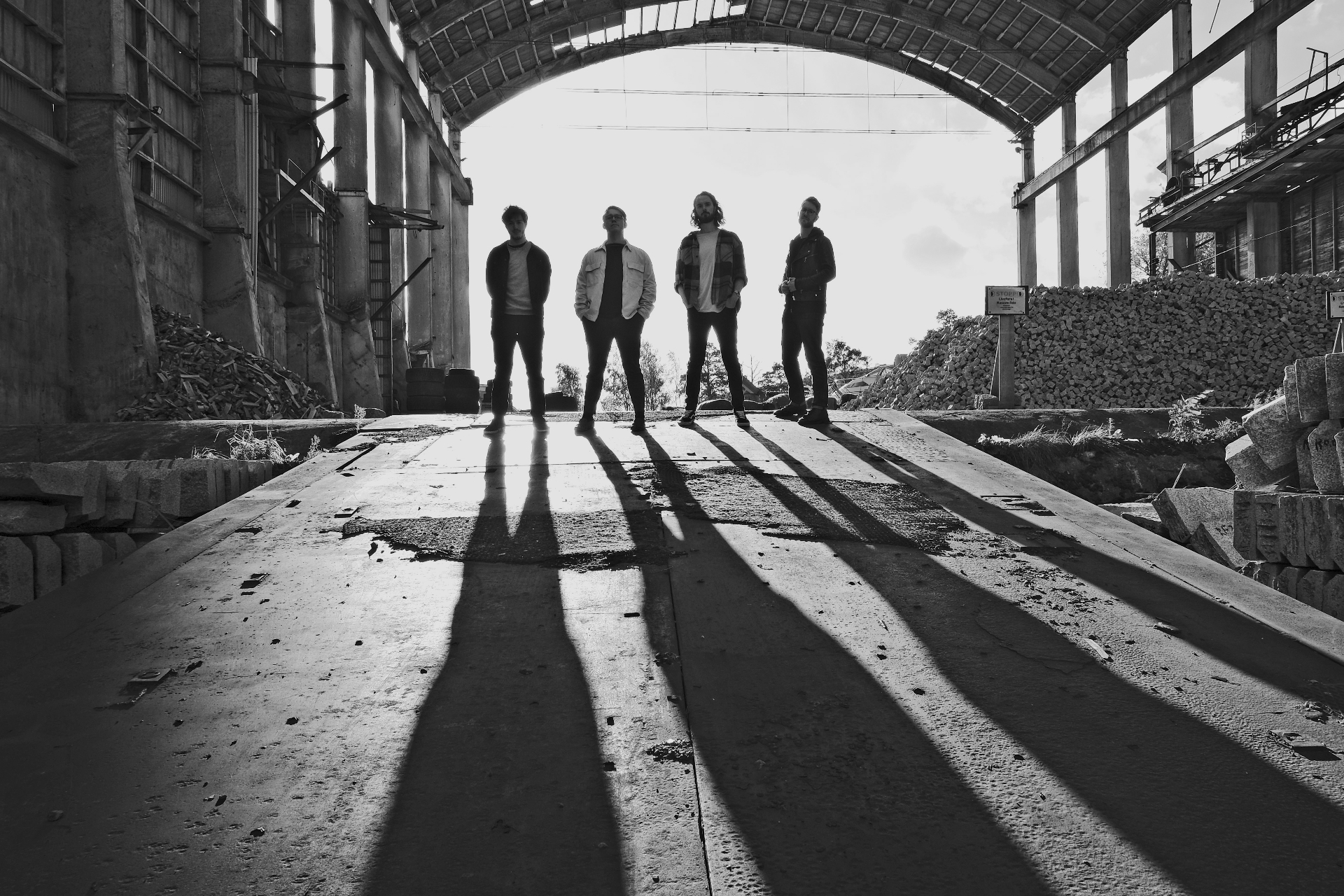 Solár black and white press photo — silhouetted under archway